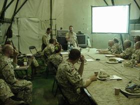 U.S. Army Civil Affairs officers Lieutenant Colonel Leonardo Rivera and Lieutenant Colonel "Diesel Joe" Smith brief incoming Poles on the situation in south-central Iraq. The briefing took place at Camp Babylon on September 2, 2003.